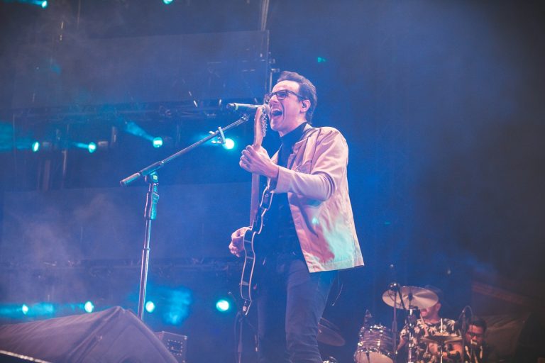a man on stage singing into a microphone